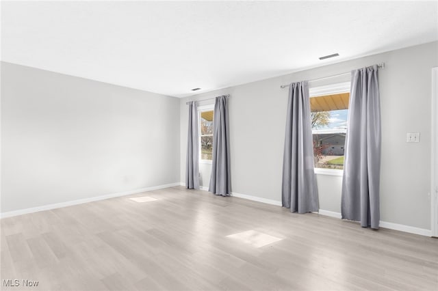 spare room featuring light hardwood / wood-style floors