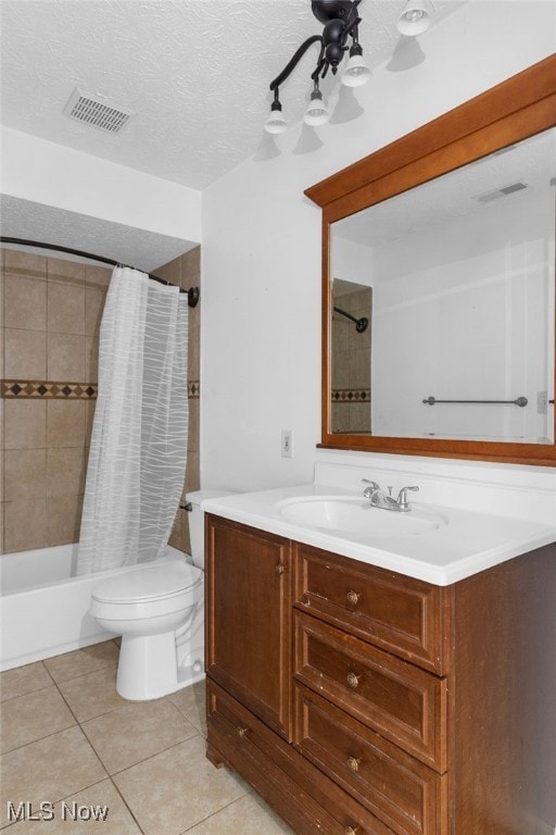 full bathroom with tile patterned flooring, a textured ceiling, toilet, shower / tub combo with curtain, and vanity