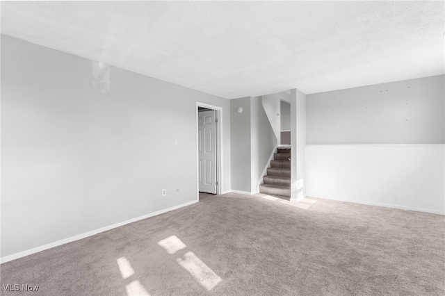 empty room featuring a textured ceiling and carpet floors