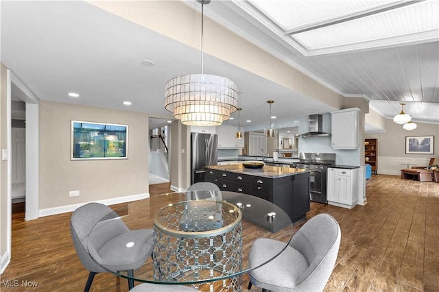 dining room with dark hardwood / wood-style floors, sink, and a chandelier