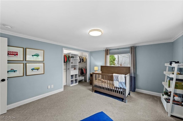 bedroom with ornamental molding, light carpet, and a closet