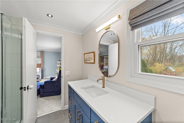 bathroom featuring ornamental molding, plenty of natural light, tile patterned flooring, and vanity