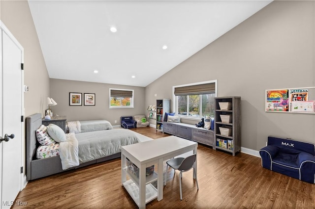 bedroom with wood-type flooring and high vaulted ceiling