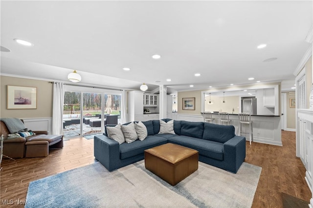 living room featuring crown molding and light hardwood / wood-style floors