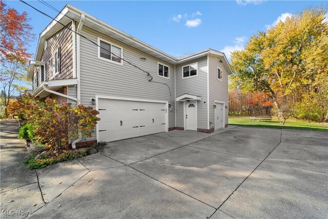 view of side of home featuring a garage