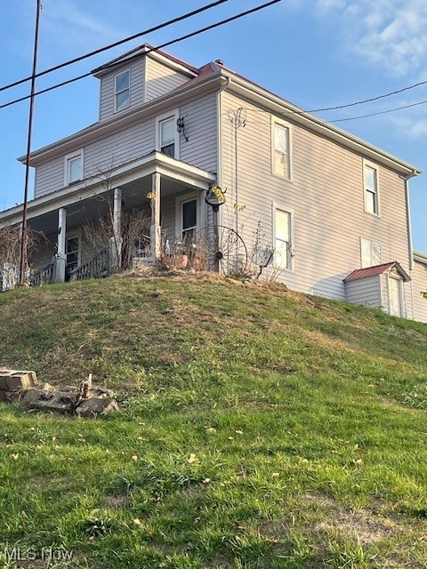 rear view of house with a lawn