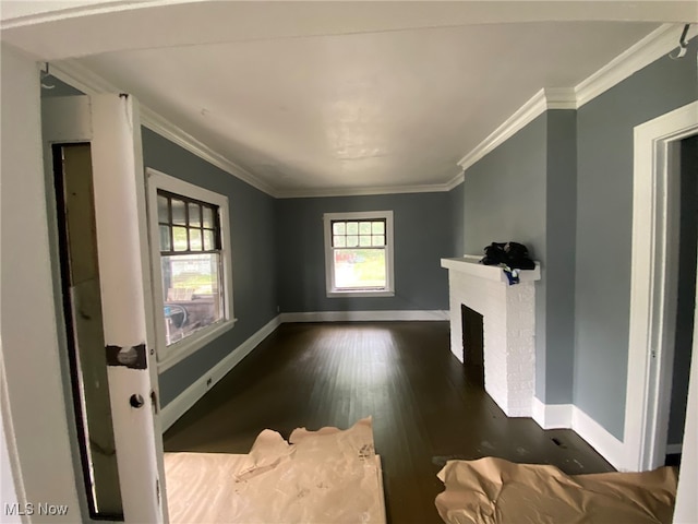 unfurnished living room featuring crown molding, a fireplace, and dark hardwood / wood-style floors