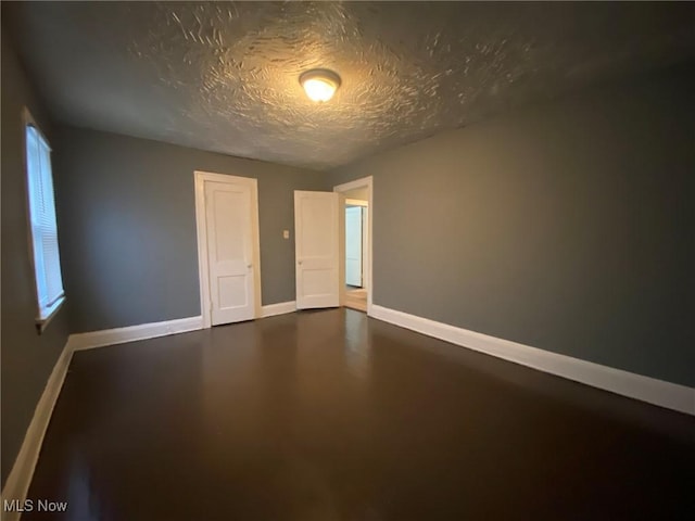 spare room with a textured ceiling