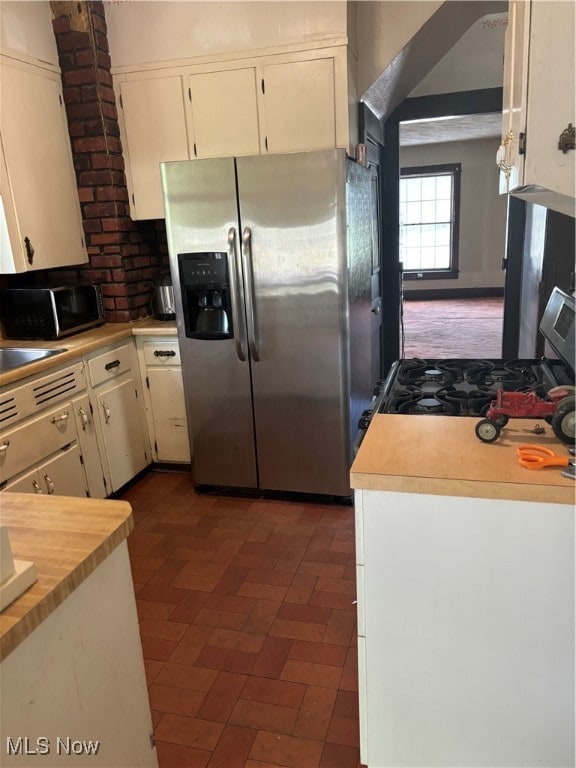 kitchen with white cabinetry and stainless steel appliances