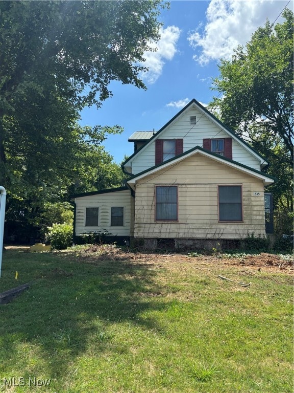 view of property exterior with a lawn