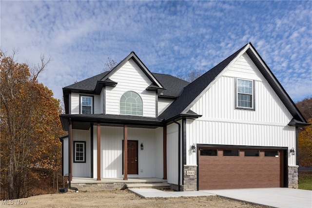 view of front of home with covered porch and a garage