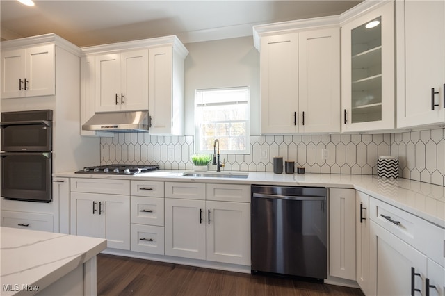 kitchen with appliances with stainless steel finishes, sink, white cabinetry, and exhaust hood