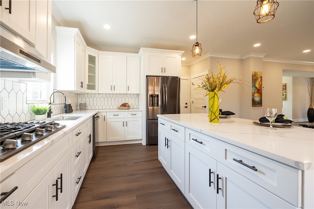 kitchen with white cabinetry, sink, and range hood