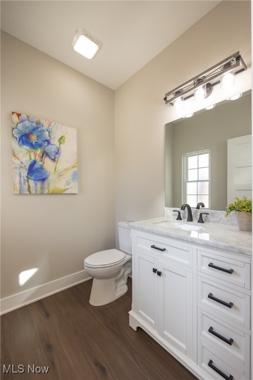 bathroom featuring hardwood / wood-style floors, vanity, and toilet