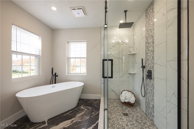 bathroom with shower with separate bathtub, a healthy amount of sunlight, and a textured ceiling