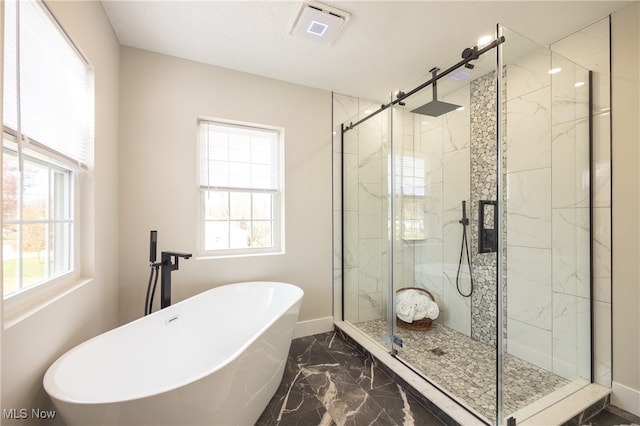 bathroom featuring separate shower and tub