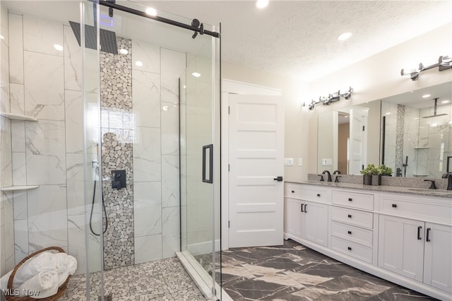 bathroom featuring vanity, a textured ceiling, and walk in shower