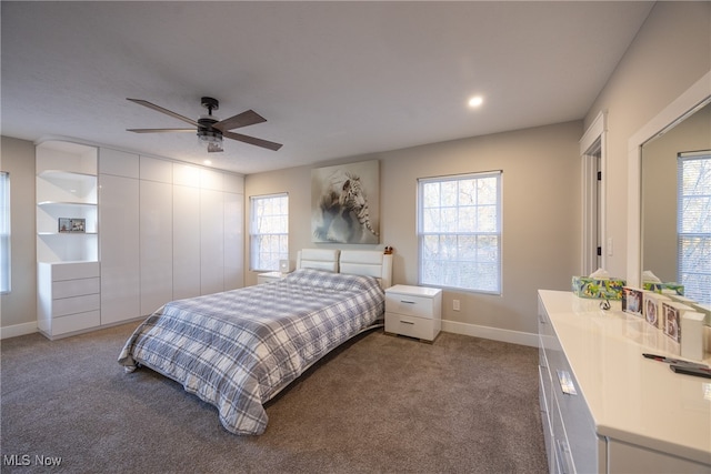 carpeted bedroom with multiple windows and ceiling fan