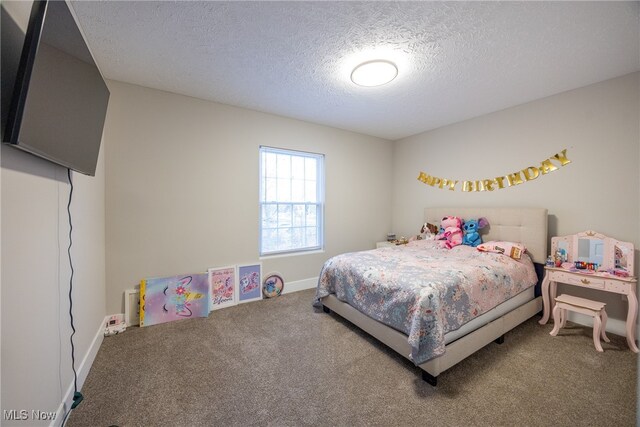 carpeted bedroom with a textured ceiling