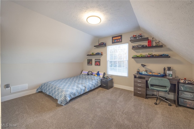 carpeted bedroom with a textured ceiling and lofted ceiling