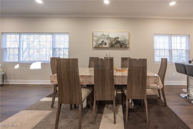 dining space featuring dark hardwood / wood-style flooring, plenty of natural light, and ornamental molding