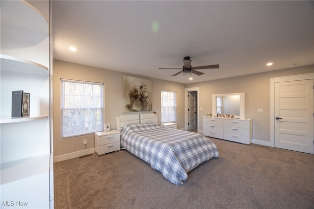 carpeted bedroom featuring ceiling fan and multiple windows