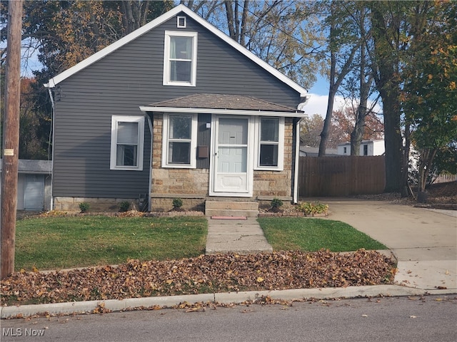 bungalow-style home featuring a front yard