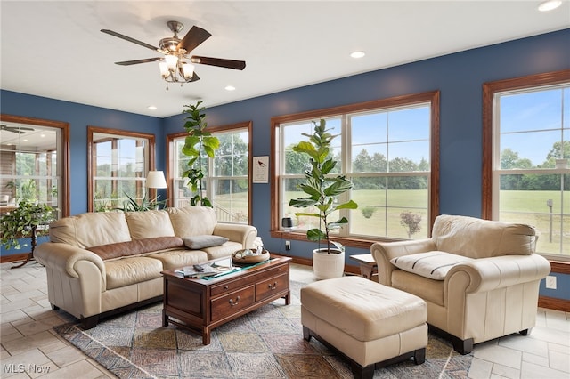 living room with a wealth of natural light and ceiling fan