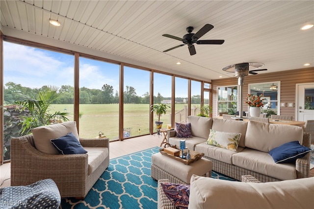 sunroom / solarium with wood ceiling, a wealth of natural light, and ceiling fan