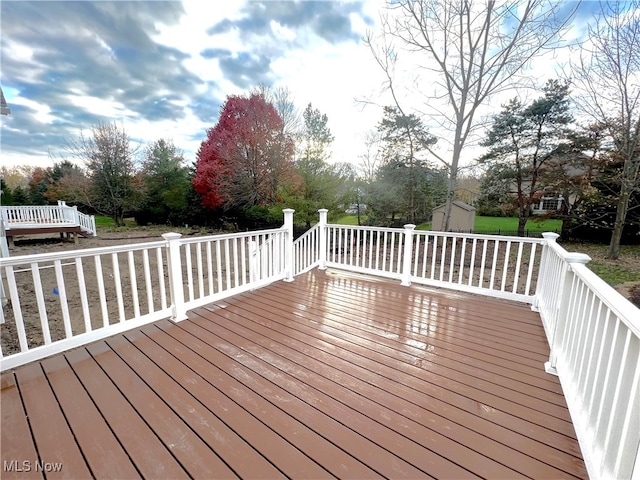 wooden deck featuring a shed