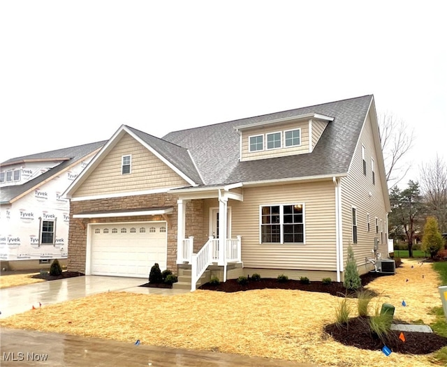 view of front of home with a garage and cooling unit