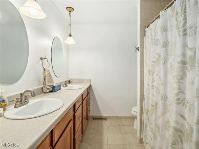 bathroom with curtained shower, tile patterned floors, crown molding, toilet, and vanity