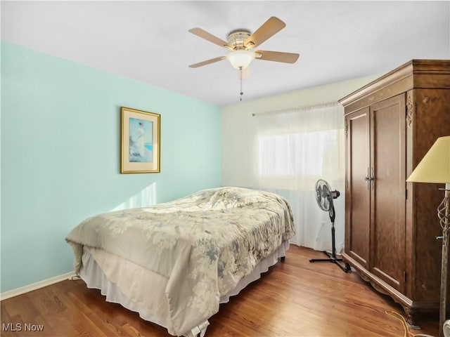 bedroom with hardwood / wood-style floors and ceiling fan