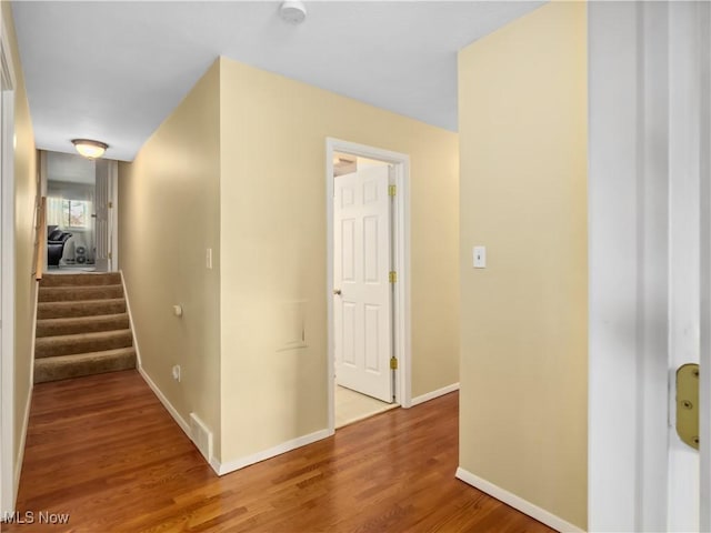 hall with hardwood / wood-style flooring