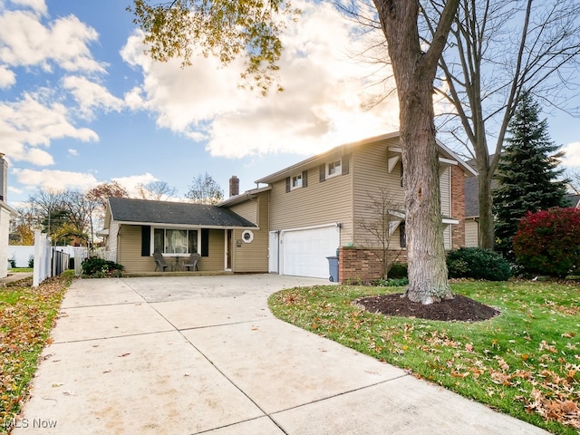 view of front of home featuring a garage and a front yard