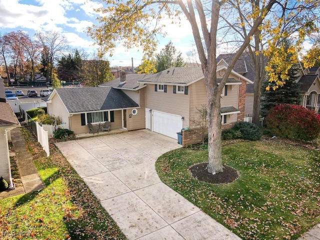 front of property with a front yard and a garage