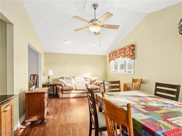 dining room featuring ceiling fan, hardwood / wood-style floors, and lofted ceiling