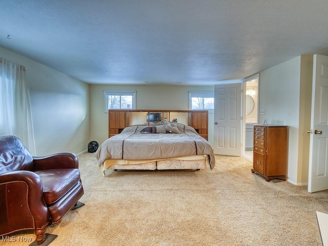 bedroom featuring a textured ceiling and light carpet