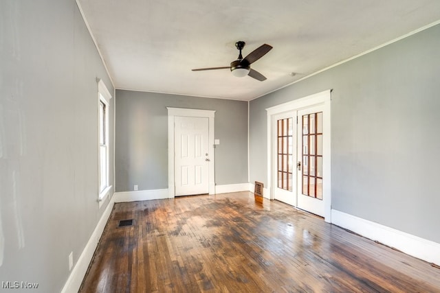 unfurnished room with french doors, dark hardwood / wood-style flooring, ceiling fan, and crown molding