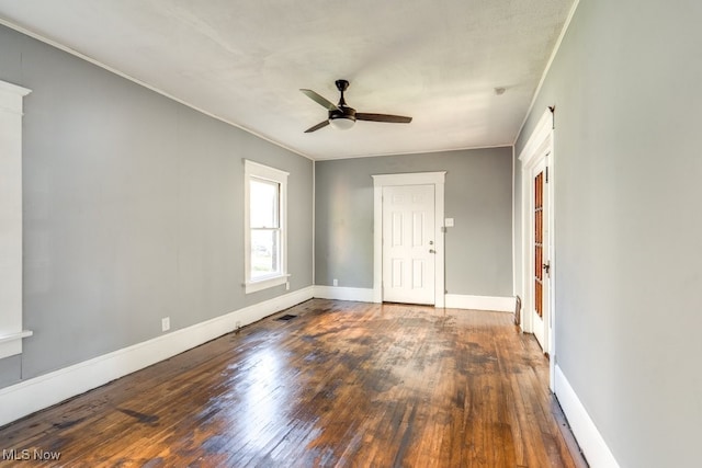 spare room featuring ceiling fan, crown molding, and dark hardwood / wood-style floors