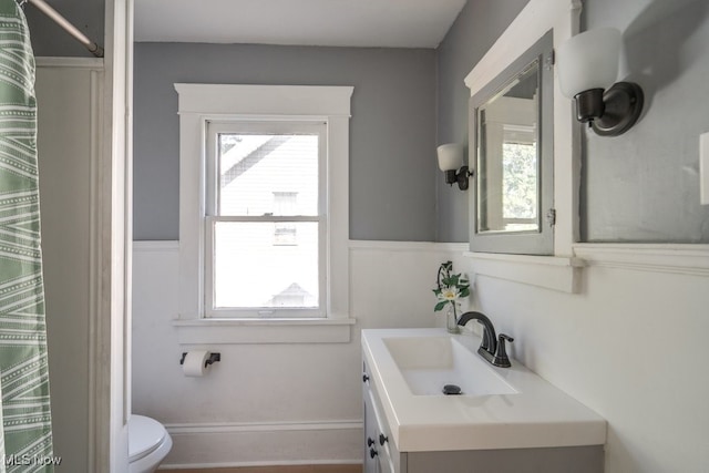 bathroom featuring vanity and toilet