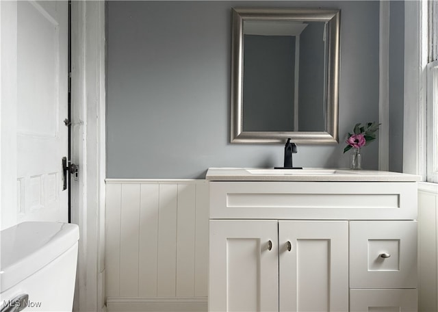 bathroom featuring vanity and toilet