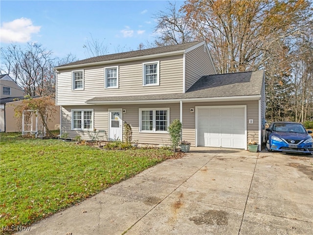 front of property featuring a front yard and a garage