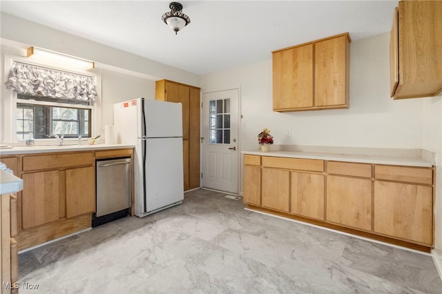 kitchen featuring light brown cabinets and white fridge