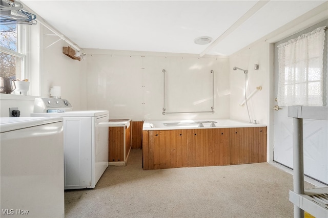 clothes washing area with washer / dryer