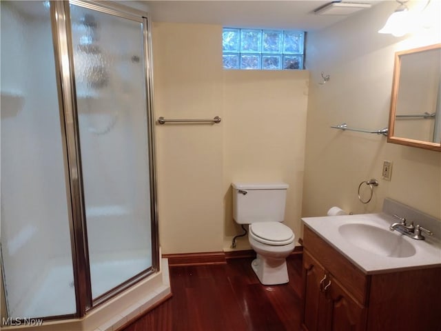 bathroom with wood-type flooring, toilet, and vanity