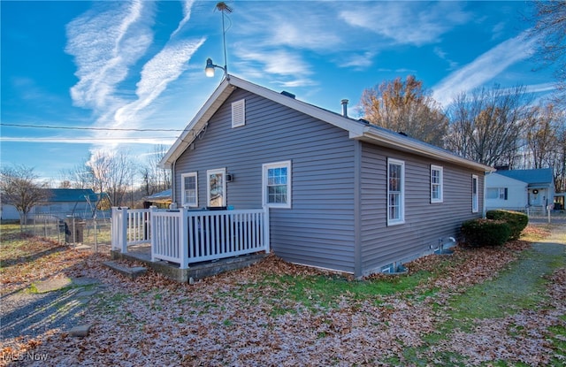 view of property exterior featuring a wooden deck