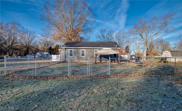 rear view of property featuring a lawn