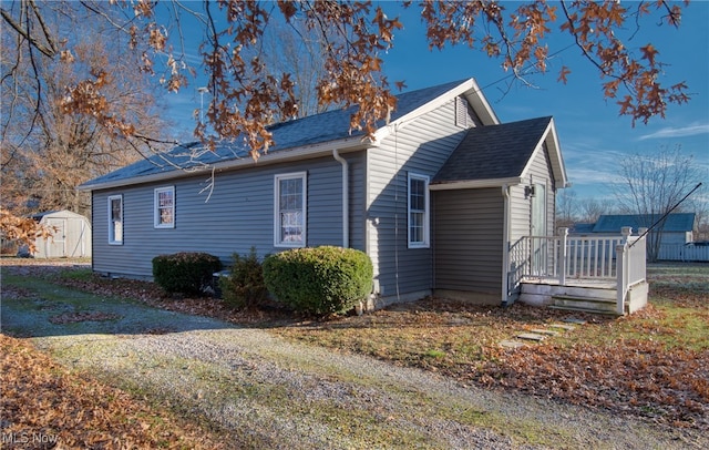 view of side of property featuring a shed