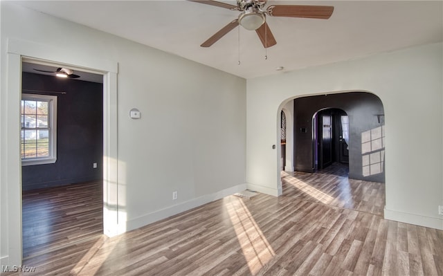 spare room with hardwood / wood-style flooring and ceiling fan